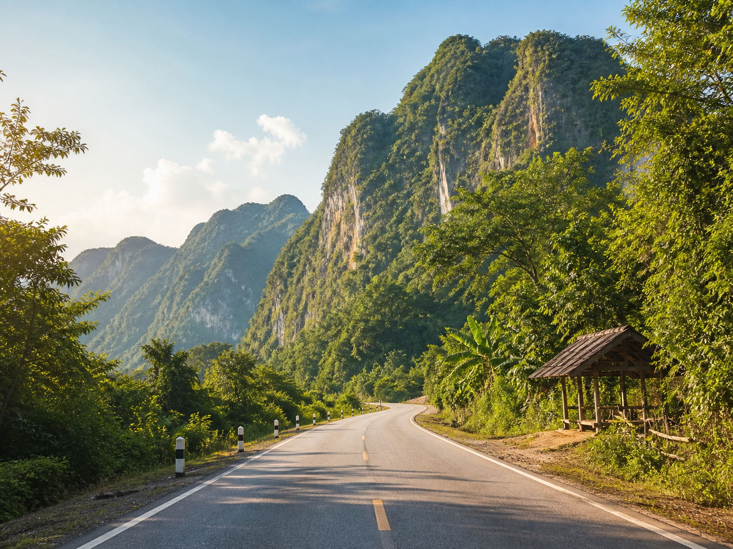 Open road through green limestone mountains in Laos